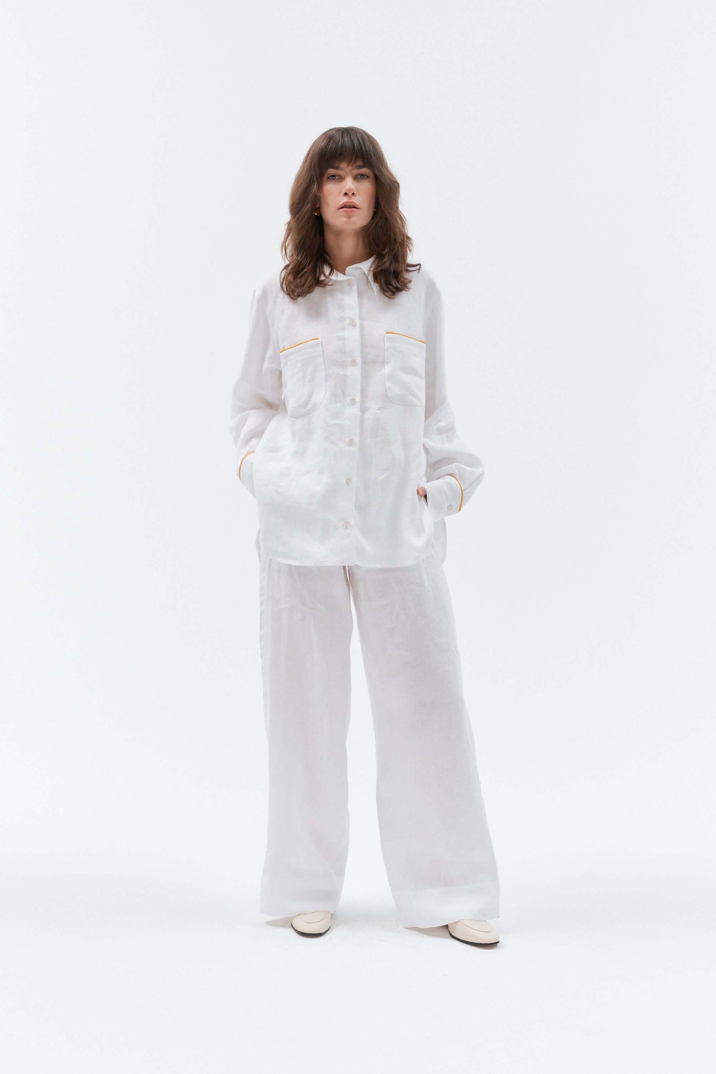 Grand Duchess women is wearing long sleeve white linen shirt with yellow stripes; oversize white linen shirt for women; women's white 100% linen shirt