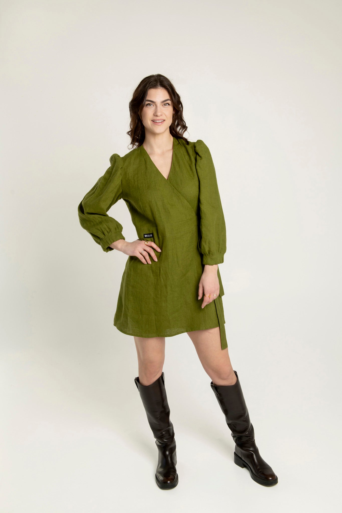 Madeleine crossover linen mini dress in olive green with adjustable waist, two side pockets.