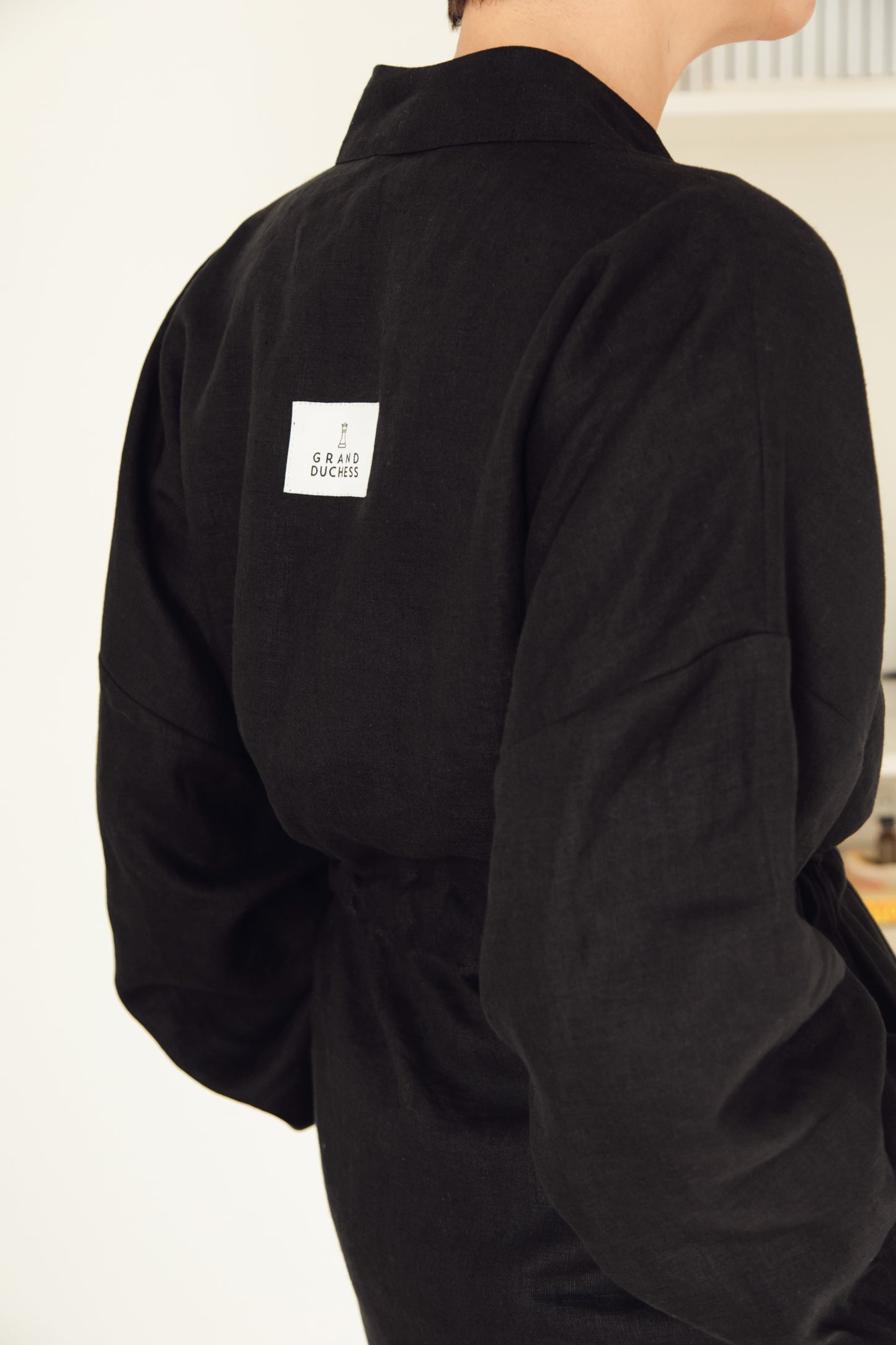 Women's short linen robe in black.