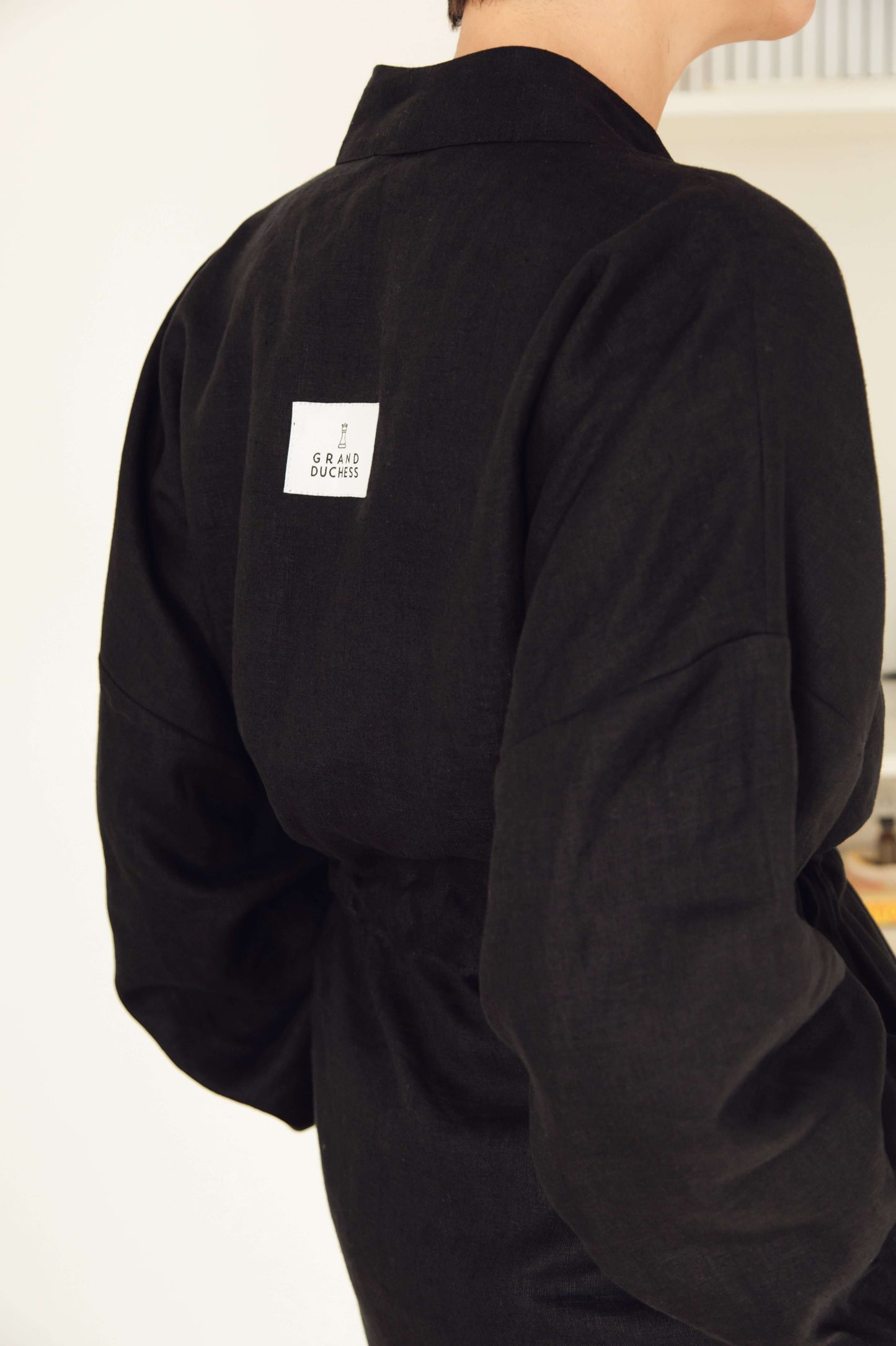 Women's short linen robe in black.