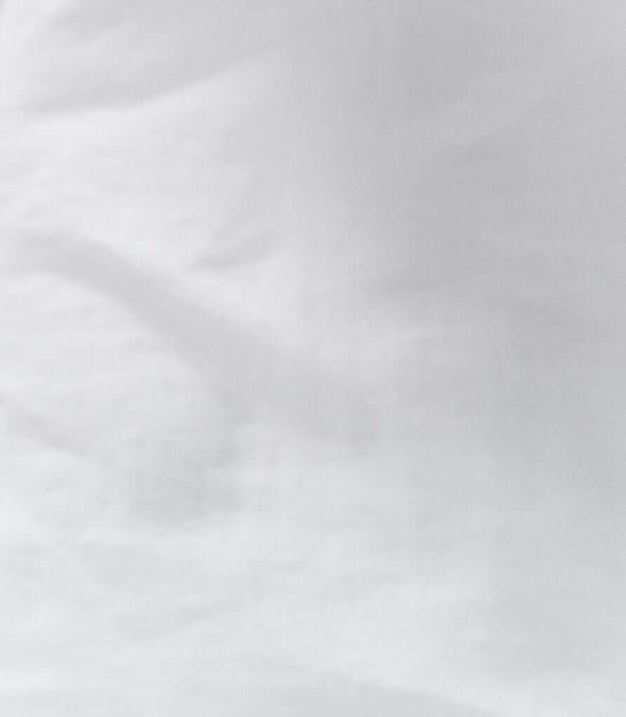 Close-up of white fabric showcasing the texture of the women's oversized long sleeve linen shirt Brillante.