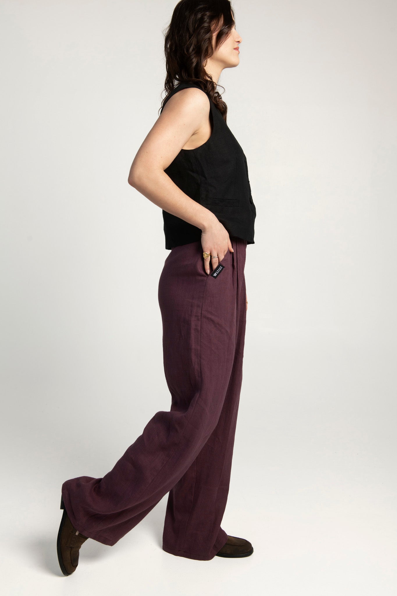 Women's high-waisted wide-leg linen pants in plum color.