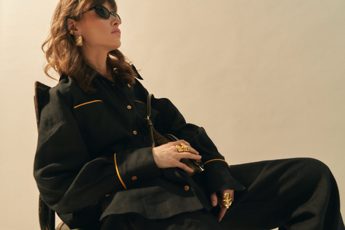 Woman wearing a stylish black linen outfit with oversized silhouette, showcasing a women's oversized linen shirt.