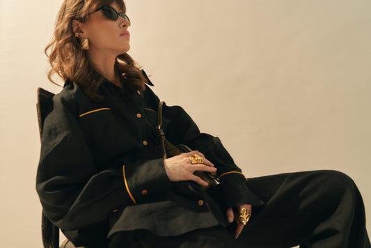 Woman wearing a stylish black linen outfit with oversized silhouette, showcasing a women's oversized linen shirt.