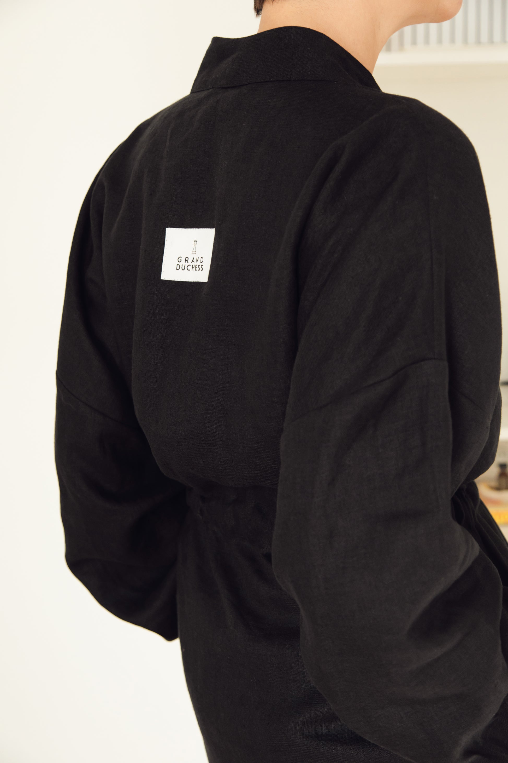 Women's short linen robe in black.