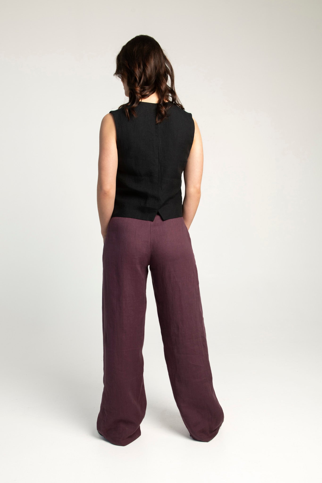 Women's high-waisted wide-leg linen pants in plum color.